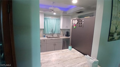 pass thru to Kitchen with ceiling fan, a raised ce
