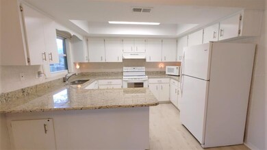 kitchen with breakfast bar and granite counter top