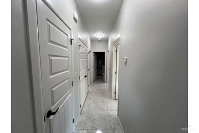 Hall featuring light marble finish floors