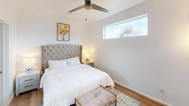 Bedroom with wood-type flooring and ceiling fan