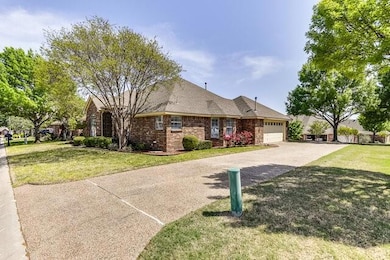 Single story home featuring a front yard, brick si