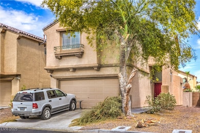 View of front of house featuring a garage, stucco