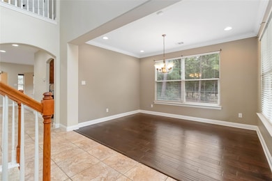 Spare room with ornamental molding, arched walkwa