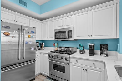 Kitchen featuring premium appliances and white cab
