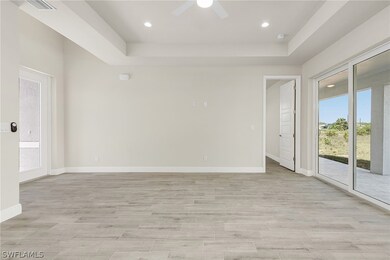 Spare room with ceiling fan and a raised ceiling