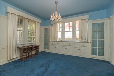 LOOK at that wall of built-ins!! Large windows all