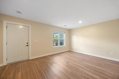 Main level flex room with entry door.