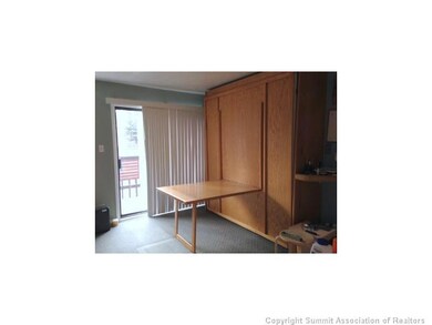 Interior Space/Layout. Murphy bed with dining tabl