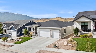 Craftsman house featuring a mountain view, an attached garage, driveway, and a shingled roof