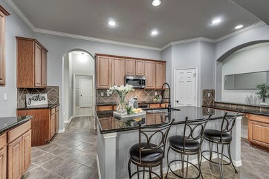 Kitchen with large island, granite countertops, walk in pantry and centrally located.