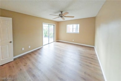 Empty room with ceiling fan and light hardwood / w