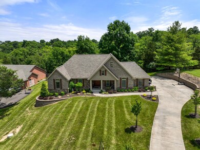 The home sits back from the road, with a wooded back drop.