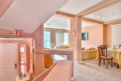 Carpeted foyer entrance featuring baseboards and r