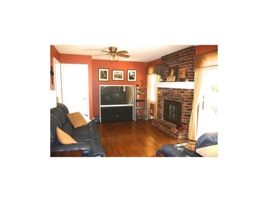 FAMILY ROOM HAS HARDWOODS AND COZY BRICK FIREPLACE