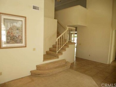 Graceful Stairway to Loft. Neutral carpet & Tile