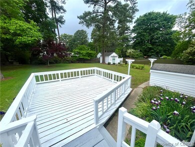Wooden terrace featuring a yard and an outdoor str