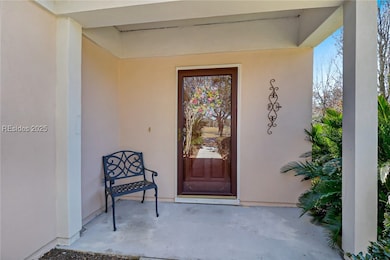 Quaint covered porch entrance welcomes family & fr