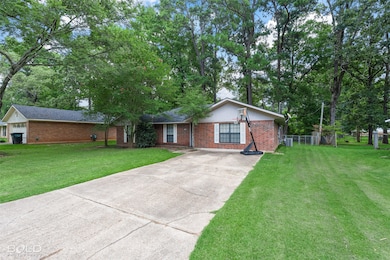 Ranch-style home with brick siding and driveway