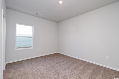 Spare room with carpet and baseboards