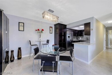 Dining space with light tile patterned floors, bas