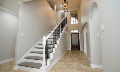 Impressive two-story entry with tile flooring all through the first floor.