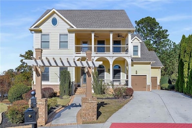 View of front of house with covered porch, a shingled roof, driveway, a ceiling fan, and brick siding
