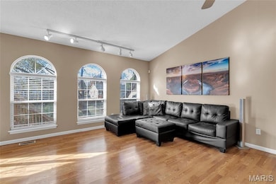 Vaulted ceiling and bank of upgraded windows offer natural light