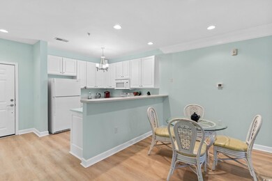 Kitchen with white cabinetry, kitchen peninsula, p