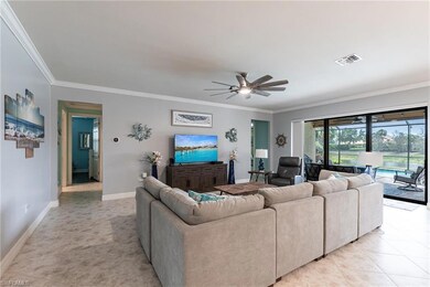 Living area featuring crown molding, visible vents