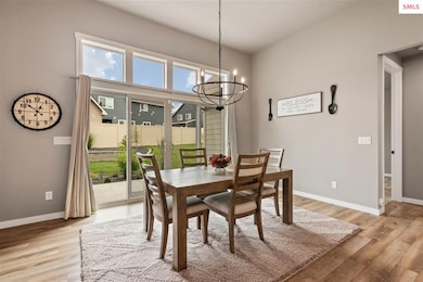 Large windows provide views of the landscaped fenc