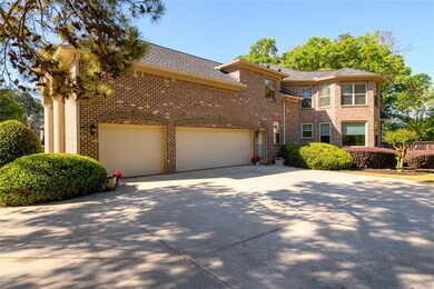 View of front of property with brick siding, a gar