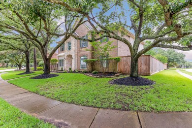 Mature trees adorn the lot enhancing the curb appeal of this brick and stone exterior home!
