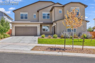 Traditional-style home with driveway, an attached garage, and stucco siding