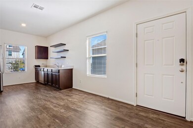 Bar area featuring dark brown cabinets, open shel