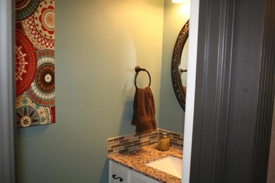 Half bath with granite countertop and decorator pa