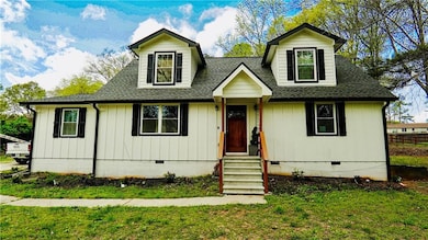 Cape cod-style house with crawl space and a shingled roof