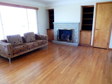 Living room with hardwood floor, decorative firepl