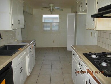 Galley kitchen with black gas cooktop, blt in oven
