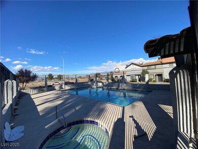 Pool featuring a patio area, fence, and a hot tub