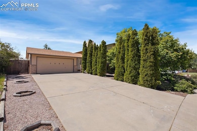 View of front of property featuring brick siding, concrete driveway, and an attached garage