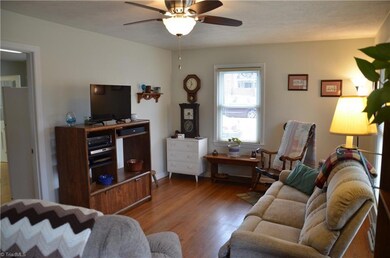 Living room has hardwood floors and is light and bright.