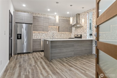 The kitchen is a standout featuring quartz countertops, gas cooking, a walk-in pantry and an oversized kitchen island.