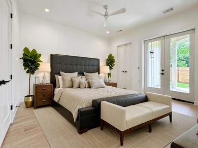 Bedroom featuring access to exterior, light wood-