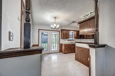 Kitchen with light tile floors, a textured ceiling