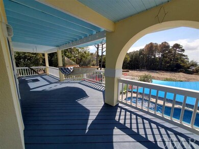 Pool side of wraparound porch with swing and hammo