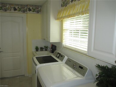 Large laundry room has sink and lots of cabinet and closet space
