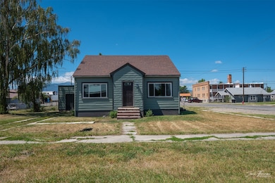 Bungalow with a front yard and roof with shingles