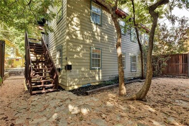 View of home's exterior featuring stairway and fe