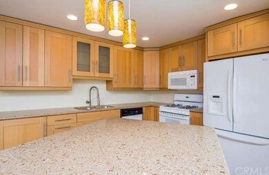 Rich toned cabinetry and beautiful white appliance