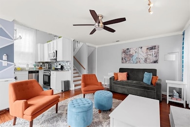 Living room featuring ceiling fan with notable cha